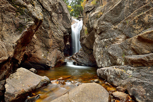 Autumn View of Chasm Falls - Horizontal Close-up autumn view of Chasm Falls, on Old Fall River Road, in Rocky Mountain National Park. devils throat stock pictures, royalty-free photos & images