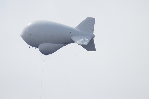 Side View of Surveilance Aerostat in Grey Sky