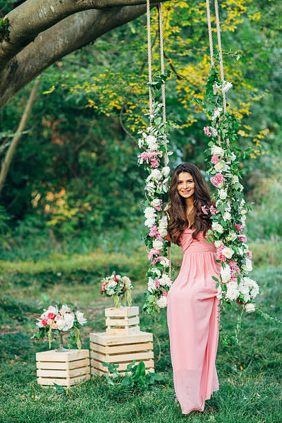 Beautiful young girl on a swing