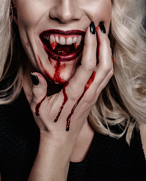 istock Woman vampire with scary blood for halloween 493055476