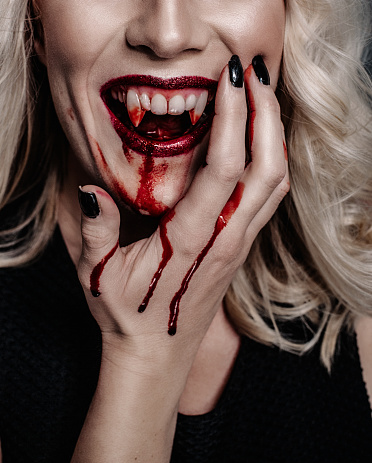 Woman vampire with scary blood for halloween