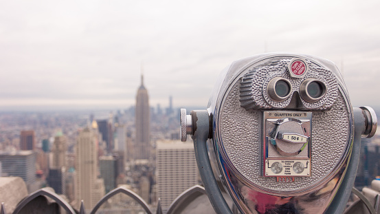 public telescope pointed on Manhattan buildings