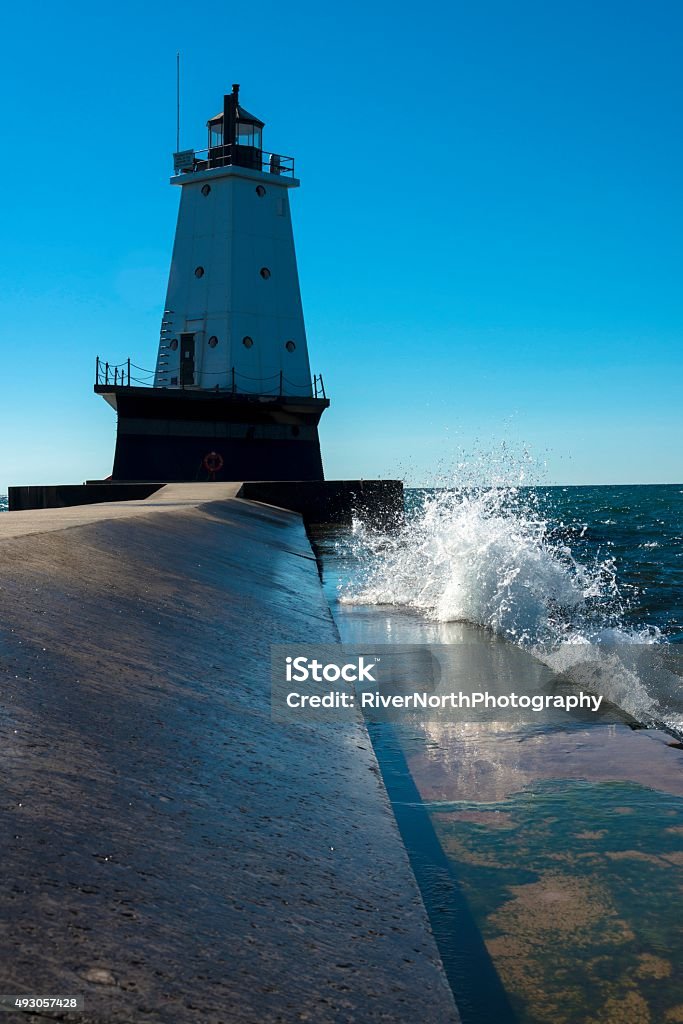 Ludington's North Breakwater Lighthouse Surf pounding against the Ludington's North Breakwater Lighthouse. Ludington - Michigan Stock Photo