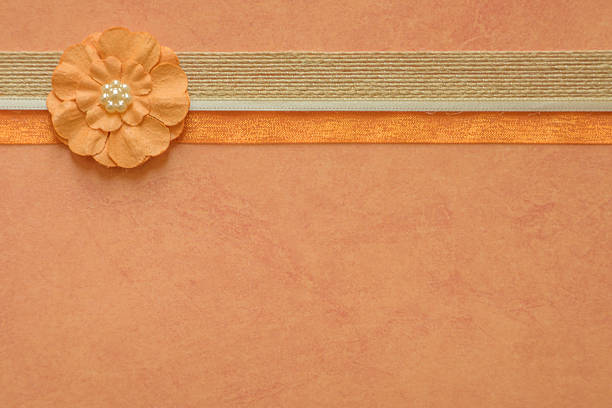 This image shows a full frame macro abstract texture design of colorful simply crafted paper flowers on a white background, with copy space.