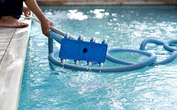 istock Man holding an equipment for cleaning  swimming pool 493060194
