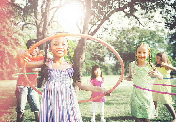 istock Children Playing Hula Hoop Activity Concept 493060640