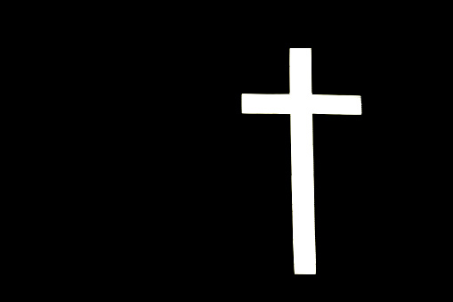 A white illuminated cross on a black background.  Plenty of copy space for religious sayings or anything else.