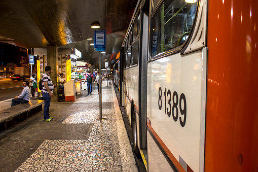 Sao Paulo, Brazil, December 02,2014:. passengers wait in platform of Ana Rosa Bus Terminal at night, in Sao Paulo, Brazil