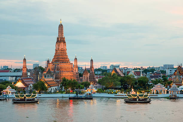 Wat Arun and cruise ship in night ,Bangkok city ,Thailand stock photo