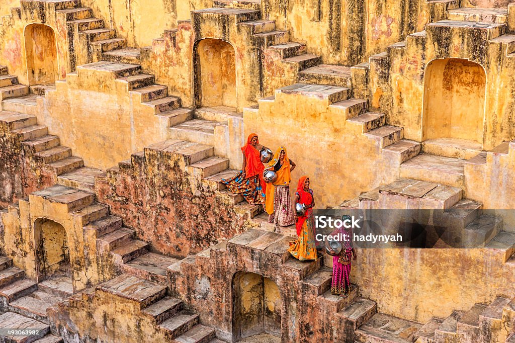 Indian women carrying water from stepwell near Jaipur Indian women carrying water from stepwell near Jaipur, Rajasthan, India. Women and children often walk long distances to bring back jugs of water that they carry on their head.  India Stock Photo