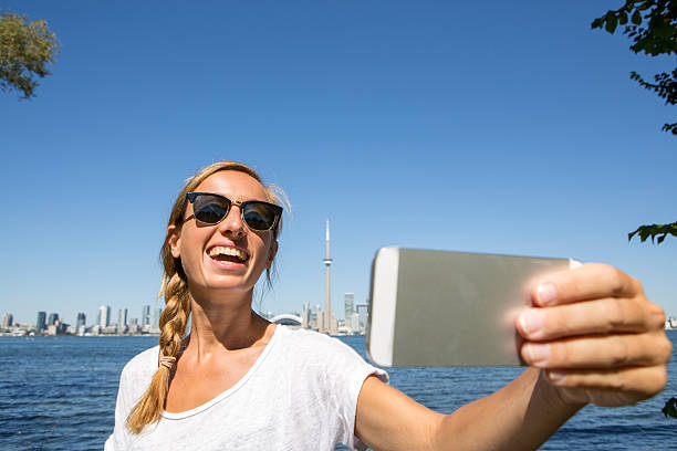 istock Cheerful student taking selfie near Toronto-Summer 493066474