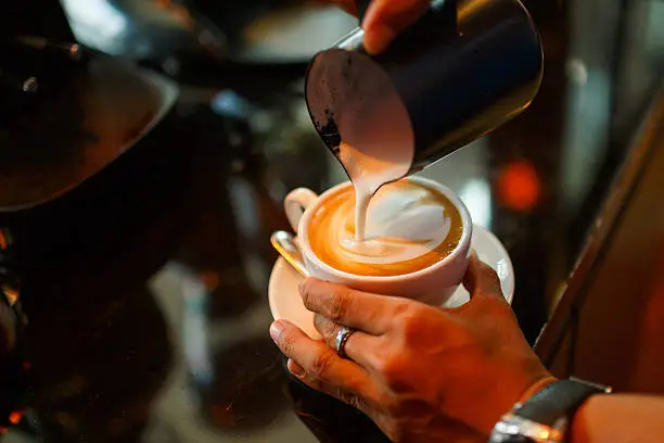 Barista making cappuccino in the coffeeshop