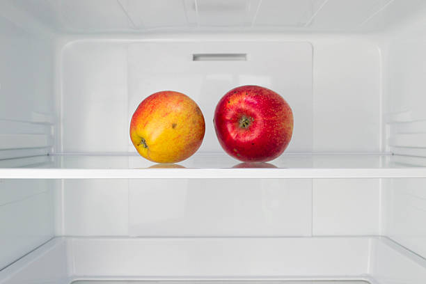 istock Apples in open empty refrigerator  Weight loss diet concept 493069355