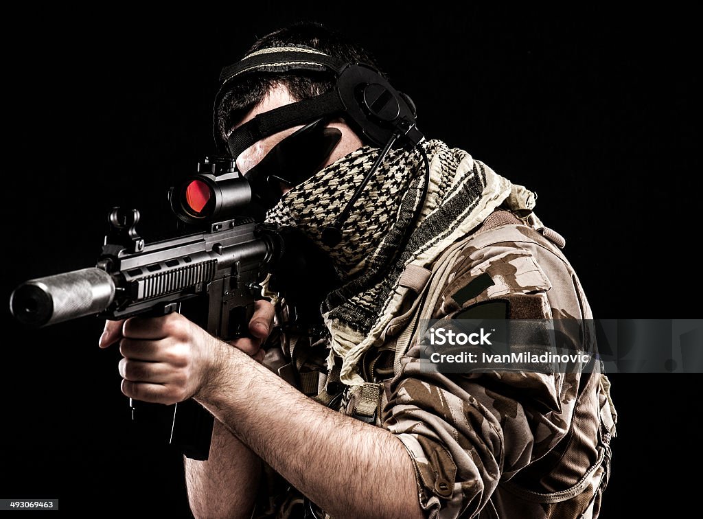 Aiming desert dressed soldier Around the world those guys keep us safe Adult Stock Photo