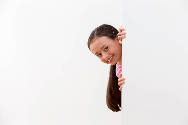 istock Girl With Cheeky Face Looking Around White Wall In Studio 493070775