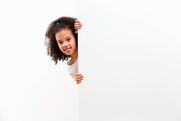 istock Girl With Cheeky Face Looking Around White Wall In Studio 493070781