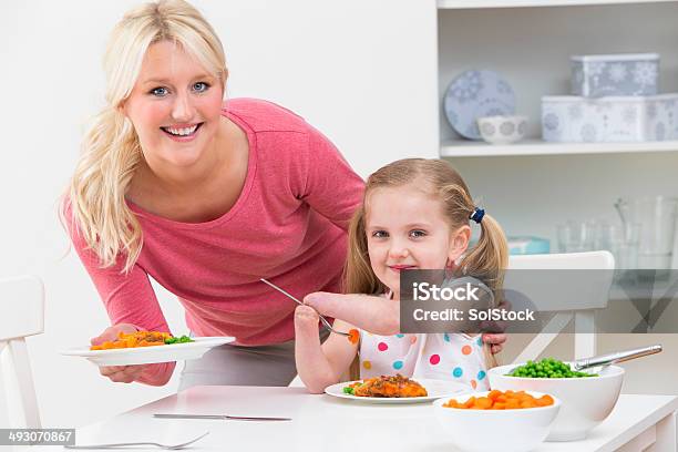 Mother With Disabled Daughter Eating Meal At Home Stock Photo - Download Image Now - Child, Disability, Eating