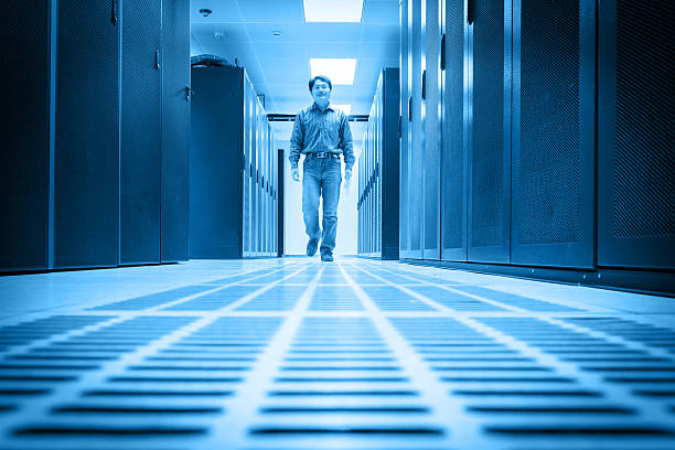 istock Administrator walking in the data center room 493071301