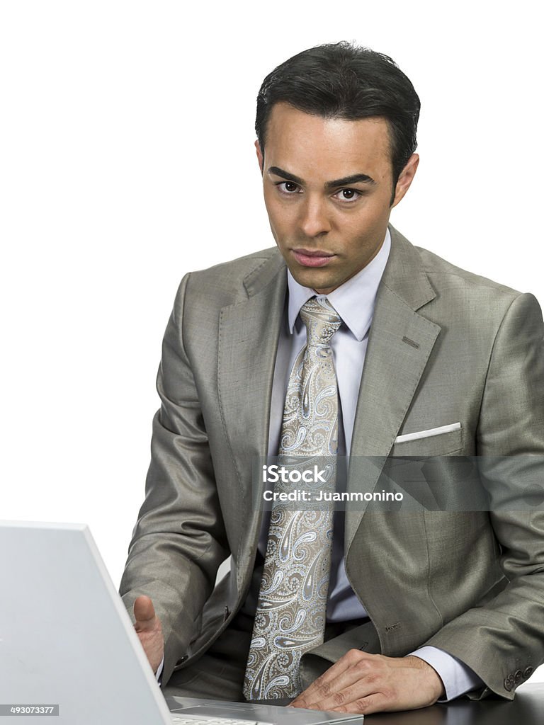 Hispanic business man Serious hispanic sitting with his laptop looking at the camera on white background 30-34 Years Stock Photo