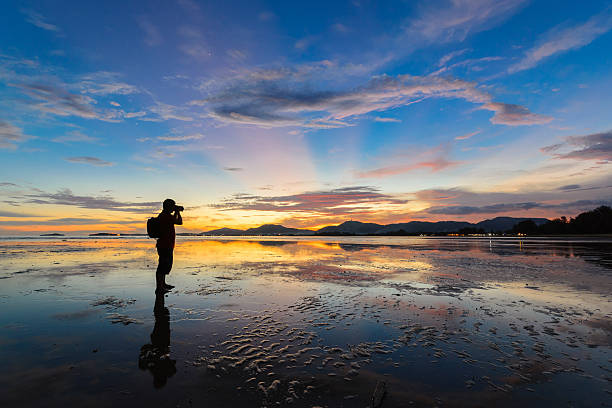 istock Photographer take a photo on colorful sunset 493073753