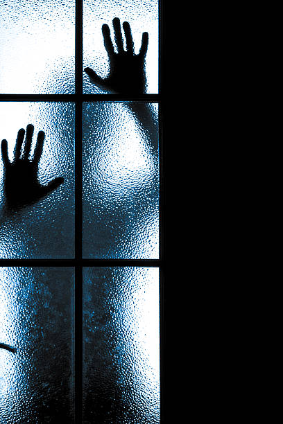 istock Scared boy behind glass door 493074179