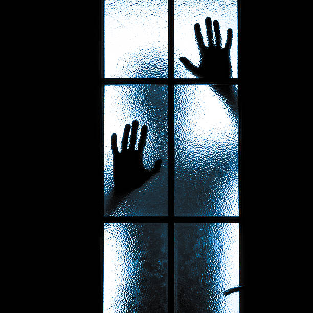 istock Scared boy behind glass door 493074185