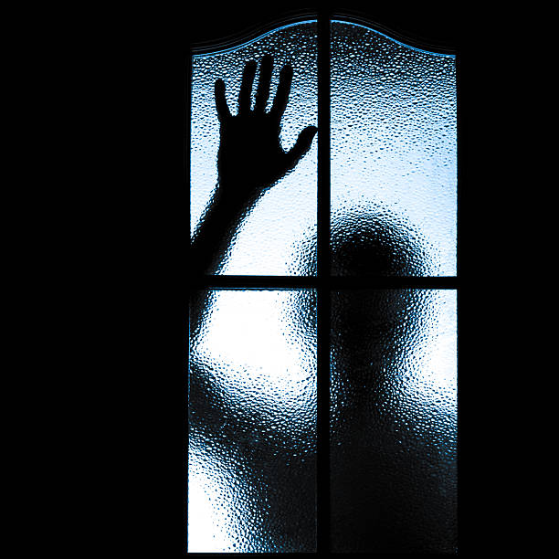 istock Scared boy behind glass door 493074189