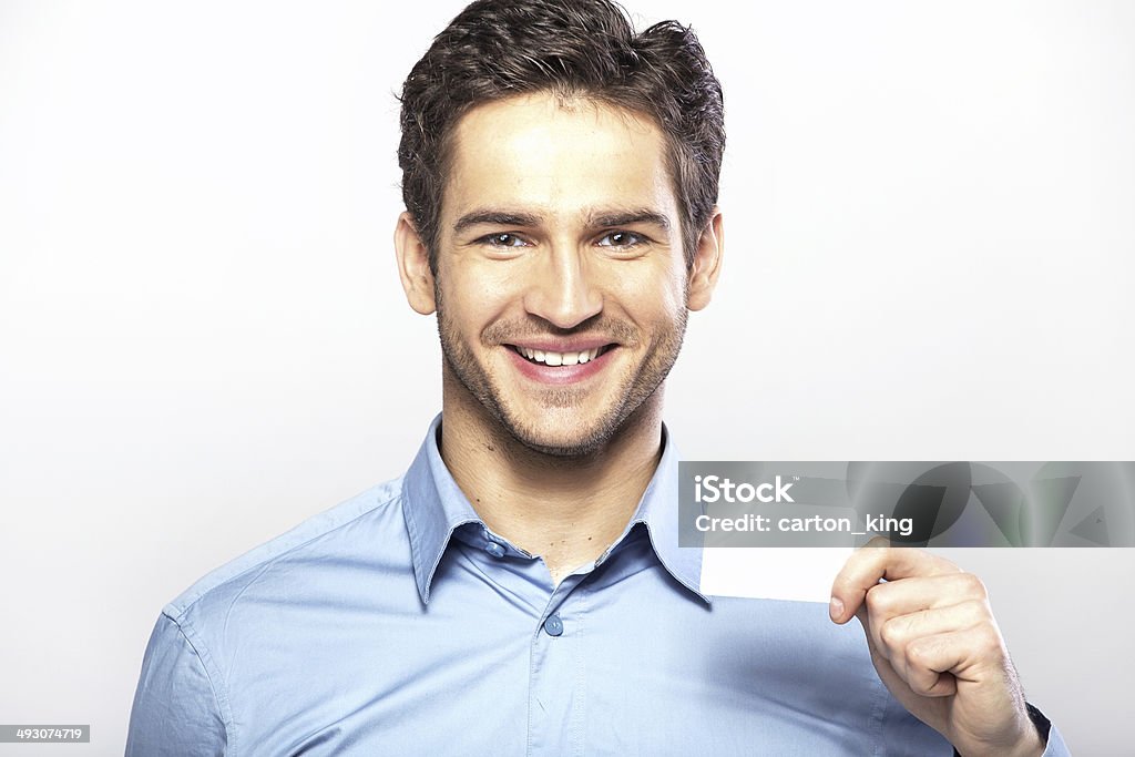 Smiling handsome guy with business card Smiling handsome man with business card White Background Stock Photo