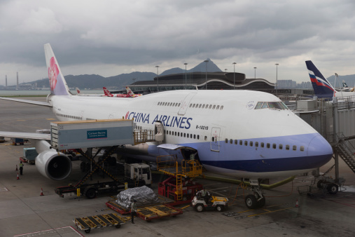 Hong Kong, Hong Kong SAR - May 14, 2014 : China Airlines Boeing 747-400 at Hong Kong International Airport. Some people are working at the airport area. 