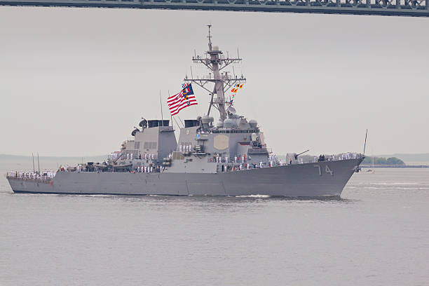 NYC Fleet Week 2014, USS McFaul destroyer, NY Harbor. New York, NY, USA - May 21, 2014: Destroyer USS McFaul (DDG 74) entering New York Harbor, for a Fleet Week. Fleet Week has held since 1984 to honor the U.S. Navy and Marine Corps. Image taken from Shore Promenade in Brooklyn. Fragment of the Verrazano Bridge is visible. Sailors are lined up on the ship's deck. destroyer photos stock pictures, royalty-free photos & images