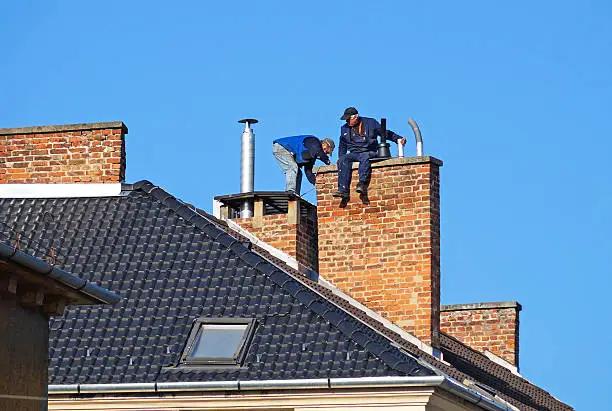 Photo of Chimney sweeps on the roof