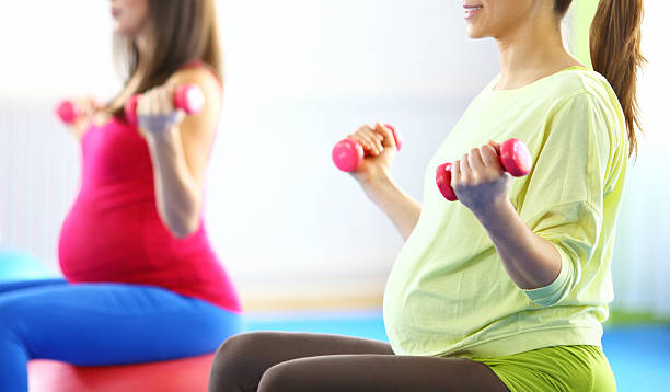 istock Group of pregnant women doing Pilates. 493078410
