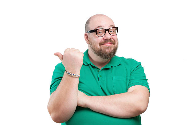 Smiling man shows his finger to the side.