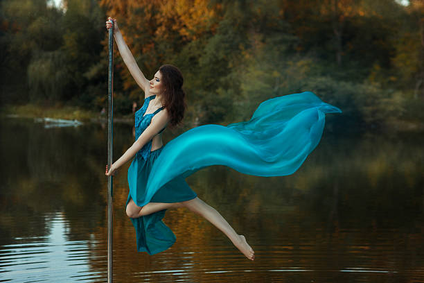 istock Girl flying dance, and her dress developing the wind. 493079380