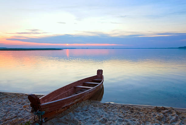 istock Sunset with boat near the summer lake shore 493083284