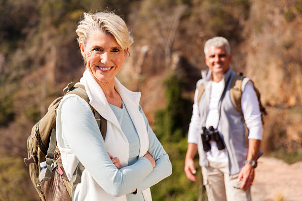 istock senior female hiker standing on mountain 493087016