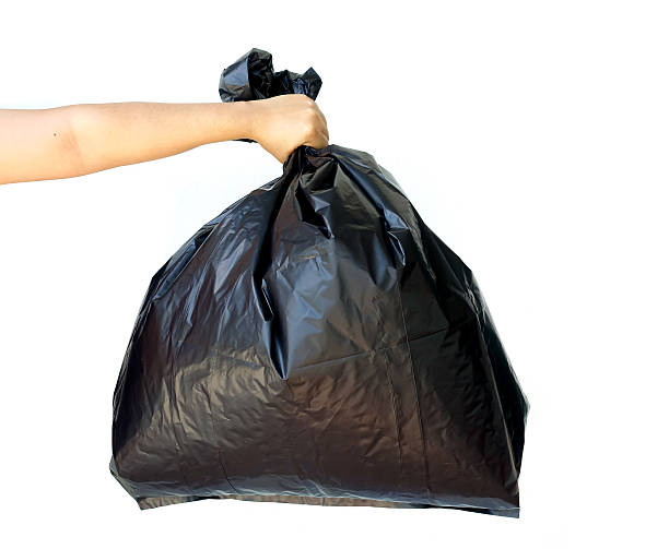 istock Woman hand holding garbage bag isolated 493087064