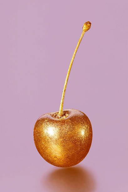 istock golden cherry on a pink background 493087230