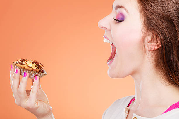 istock woman face profile holds cake in hand 493087614