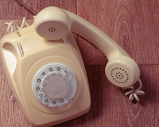 istock Retro telephone on wooden table in front gradient background 493088450