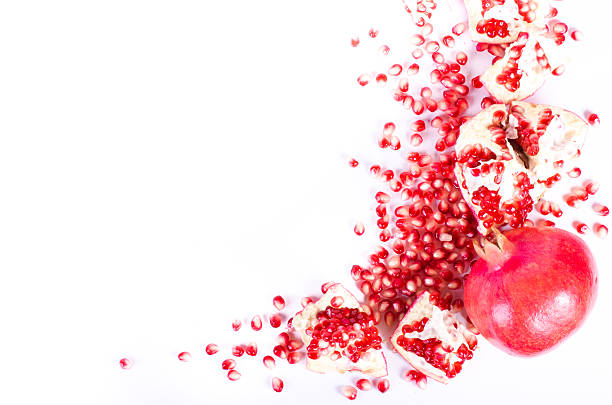 istock Ripe pomegranate fruit and seeds isolated on white 493090280