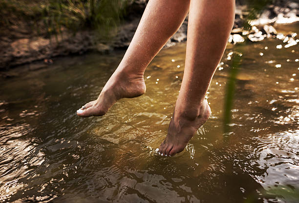 istock Unrecognizable woman's legs above the water. 493090420
