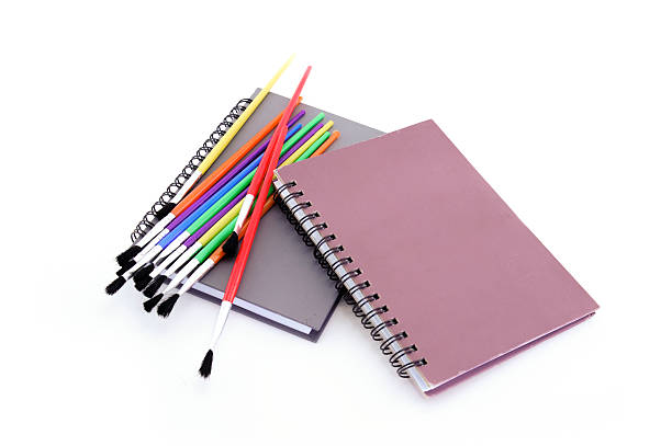 istock Notebook and pencil on weeden table and white background 493090488
