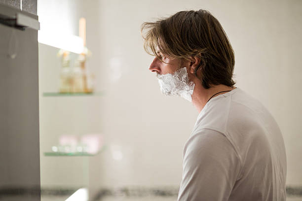 istock Profile of a man shaving in bathroom. 493105226