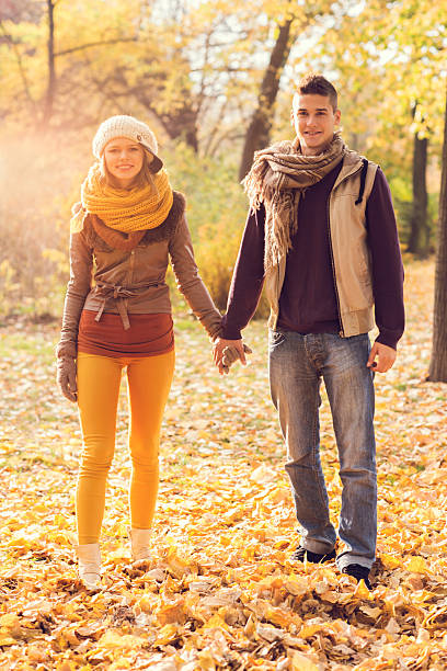 istock Smiling couple standing in autumn park and holding hands. 493105490