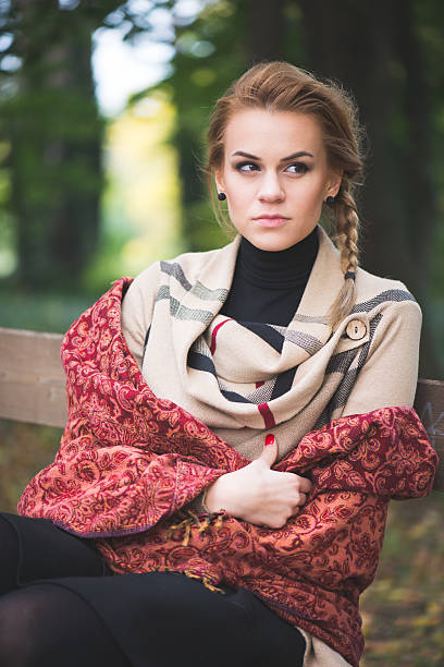 istock Beautiful young woman resting in autumn park 493105932