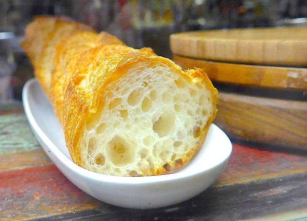 istock Sectioned french stick closeup at the bar 493106702