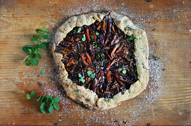 Photo of Plum galette pie with wine, almonds and marjoram