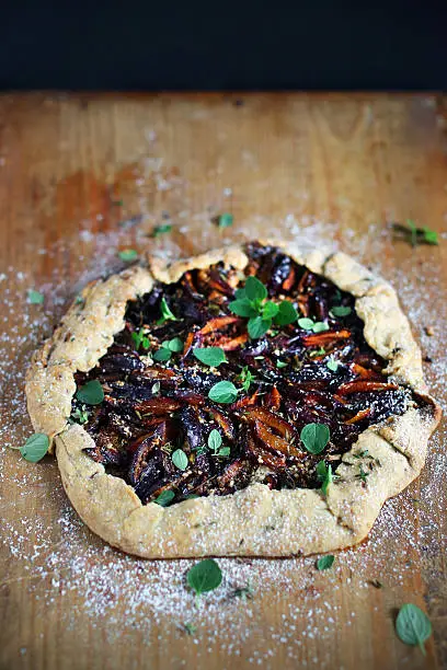 Photo of Plum and marjoram tart or galette, fresh baked pie dessert