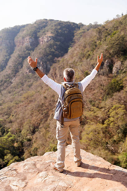 istock senior male hiker with arms open 493108494